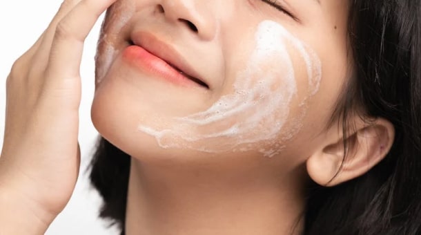 metal cage for dogs set up outdoors under shade cloth